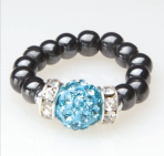 black beaded stretch ring with blue crystal accent bead