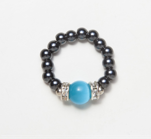 black beaded stretch ring with light blue cats eye accent bead