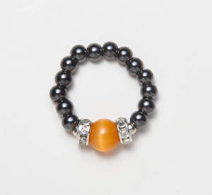 black beaded stretch ring with cat's eye orange accent bead