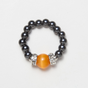 black beaded stretch ring with cats eye orange accent bead