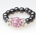 black beaded stretch ring with pink crystal accent bead