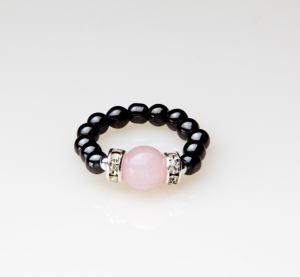 black beaded stretch ring with rose quartz accent bead